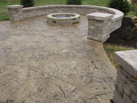 stamped concrete patio with fire pit and masonry ledges 