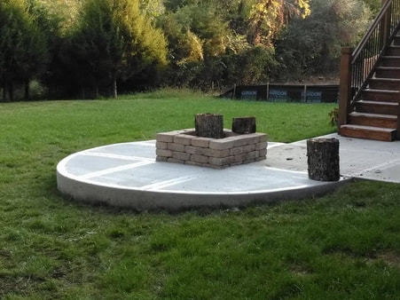 concrete slab with fire pit in the middle