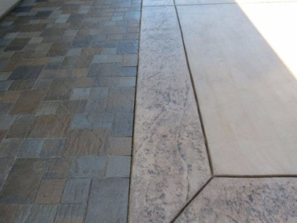 two different stamped concrete patterns side by side on looks like bricks the other is rustic dark brown 