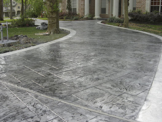stained and stamped concrete dark grey driveway